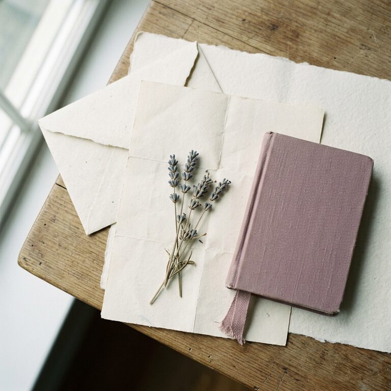 Letters, an envelope and dried lavender laid out on cream paper